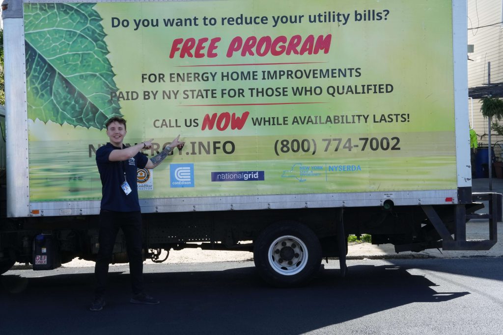 energy eco solutions worker in font of the truck with equipment for the insulation