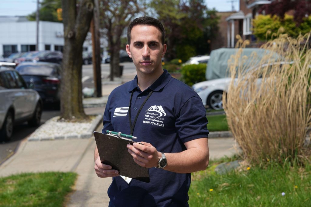 main energy eco solutions manager in front of the house in queens